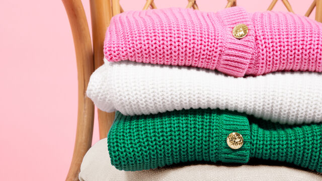 Three cardigans folded and stacked